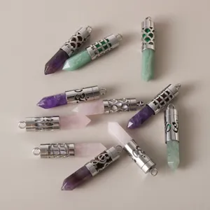 Detailed view of hollow stainless steel pendants with amethyst and rose quartz crystals