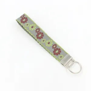 Detailed view of vintage ethnic jacquard woven wristlet keychain with floral embroidery