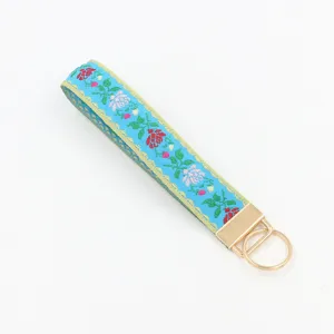 Schlüsselanhänger-Armband mit Blumenmuster in Hellblau und Gold
