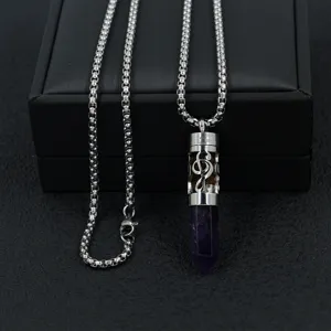 Detail view of a stainless steel music note diffuser necklace with purple crystal