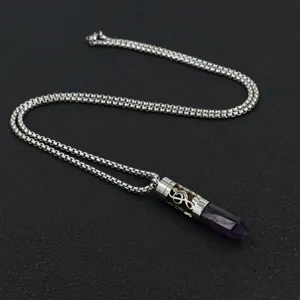 Detail of stainless steel diffuser necklace with G-clef hollow pendant and purple stone