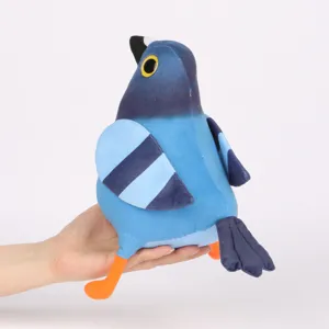 Gros plan d'une peluche Pigeon Pop bleue amusante tenue à la main montrant sa taille