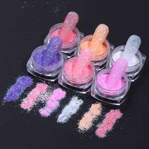 Detailed macro view of colorful glitter sugar powder for nail art displayed in clear jars