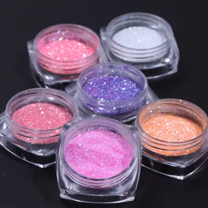 Six jars of vibrant shimmering nail art glitter powder in various colors for DIY manicure