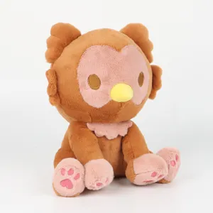 Close-up of a cute brown and pink Owlbear plush toy sitting on a clean white background