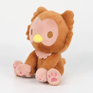 Detailed view of cute Owlbear monster plush toy sitting with heart embroidery paws