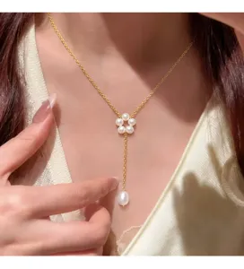 Nahaufnahme einer eleganten französischen Perlenkette mit Blumenquaste am Modell