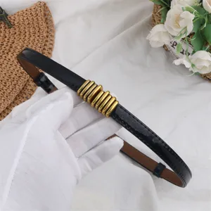 Elegant black thin leather dress belt featuring chic gold metal buckle for stylish daily wear.
