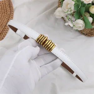 White leather belt detail shot showcasing elegant gold metal buckle, perfect for dresses and suits.