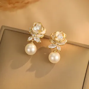 Nahaufnahme eleganter Emaille-Rosenohrringe mit edlen Perlenanhängern und Zirkonia