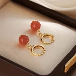 Detailansicht eleganter Creolen mit roten Achatperlen in einer Premium-Geschenkbox