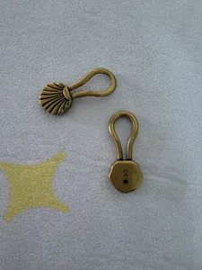 Detailed shot of vintage bronze zinc alloy belt buckle component with metal clasp design.