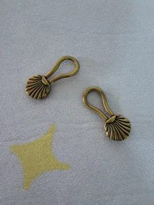 Vintage bronze metal shell cloak clasps, decorative frog closures for belts and garments.