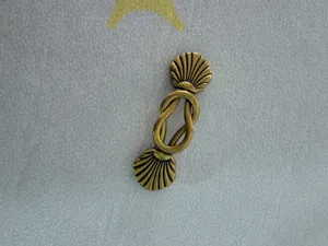 Detail view of retro bronze alloy belt buckle with shell ends and vintage clasp design.