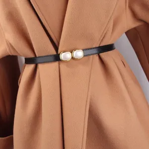 Elegant thin black waist belt with dual square pearl buckle, stylish accessory for coats.