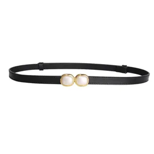 Close up view of a black thin belt featuring double geometric pearl gold-rimmed buckle.