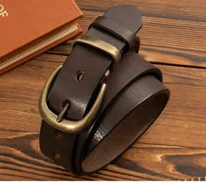 Detail view of genuine leather men belt with solid brass buckle showing close up texture and craft.
