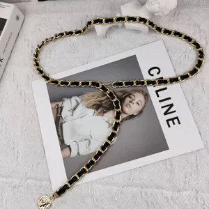 Elegant gold and black leather interlaced chain belt, classic luxury style accessory for dresses.