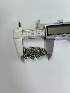 Vintage zinc alloy belt buckle detail view showing precise dimensions with measuring tool.
