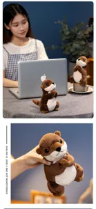Detailweergave van een schattige otter knuffel in een gebedshouding op een bureau