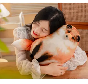 Soft round fox plush pillow being hugged by a woman in a cozy lifestyle setting
