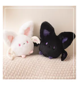 Cute pair of round bat plushies in black and white, perfect for spooky Halloween decor