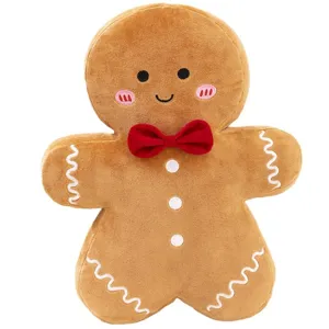 Peluche de bonhomme de pain d'épice de Noël mignonne avec un nœud rouge et broderies