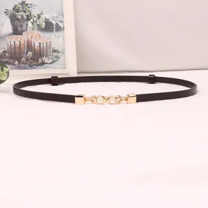 Elegant women's slim leather dress belt with delicate gold buckle and faux pearls.