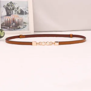 Elegant thin brown leather dress belt with chic pearl gold buckle detail for women fashion.