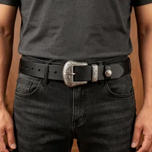 Detailed view of wide leather belt with retro engraved alloy buckle, stylish cowhide accessory.