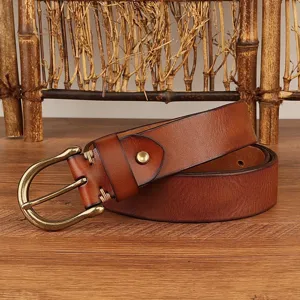 Close-up of men's vintage genuine leather belt with classic horseshoe brass buckle detail.