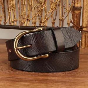 Detailed close-up view of vintage brown leather belt with brass horseshoe metal buckle.
