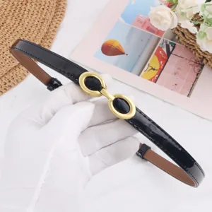 Black patent leather skinny belt with chic gold-toned interlocking double buckle design.