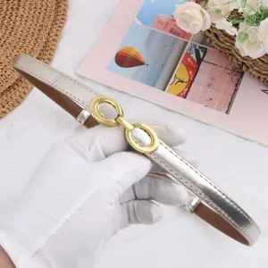 Elegant silver thin leather belt for women with retro gold interlocking buckle for fashion.