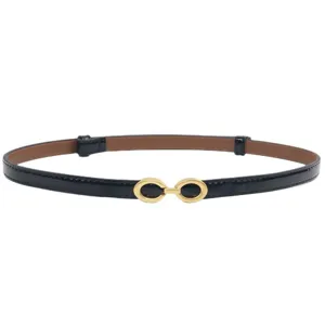 Black patent leather thin belt for women with chic gold double buckle, stylish waist accessory.