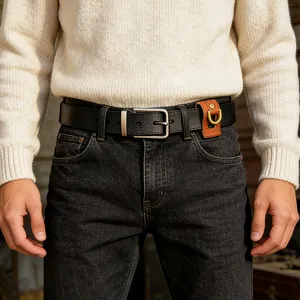 Close-up detail of mens genuine leather belt with metal buckle and small leather key holder.