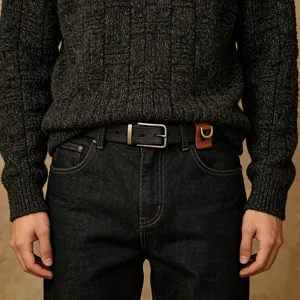 Detailed view of genuine leather men belt with key holder and metal buckle accessory.