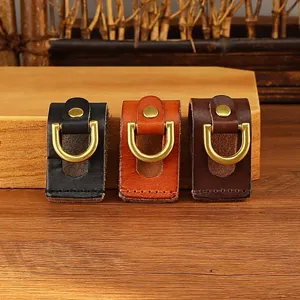 Detailed view of handmade leather belt loop key holder with brass D-ring in three colors.