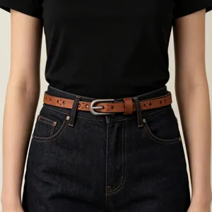 Detailed close-up view of women's brown leather thin belt with vintage cutout style.