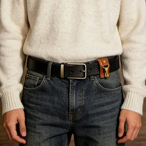 Detailed close-up shot of a black leather belt with a brown key holder accessory fastened.