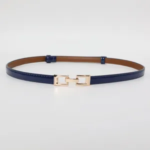 Close-up detail of a slim navy blue leather belt with an elegant gold buckle, perfect accessory.