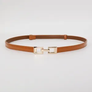 Brown patent leather thin belt detail, stylish golden metal buckle, elegant women accessory.