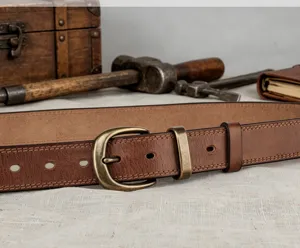 Vintage vegetable-tanned genuine leather belt with brass buckle detail close up shot.