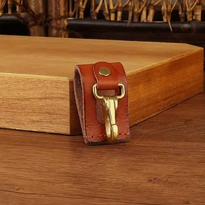 Brown leather key holder belt clip with brass hook, durable everyday carry accessory for men.