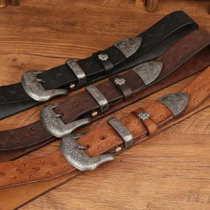 Retro genuine leather embossed belt set with intricate metal carved buckles and decorative tips.