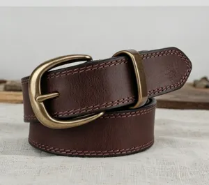 Detailed close-up of retro brown leather belt featuring brass buckle and fine stitching.