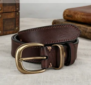 Vintage brown leather belt detail, top cowhide with sturdy stitching and classic brass buckle.