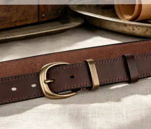 Close-up detail view of women vintage genuine leather belt with brass buckle and stitching.
