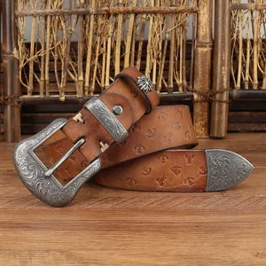 Close-up of retro embossed leather belt with ornate floral engraved metal buckle details.