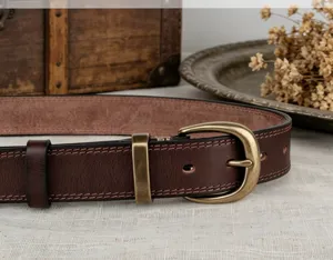 Detail view of women's vintage vegetable-tanned cowhide leather belt with brass buckle.